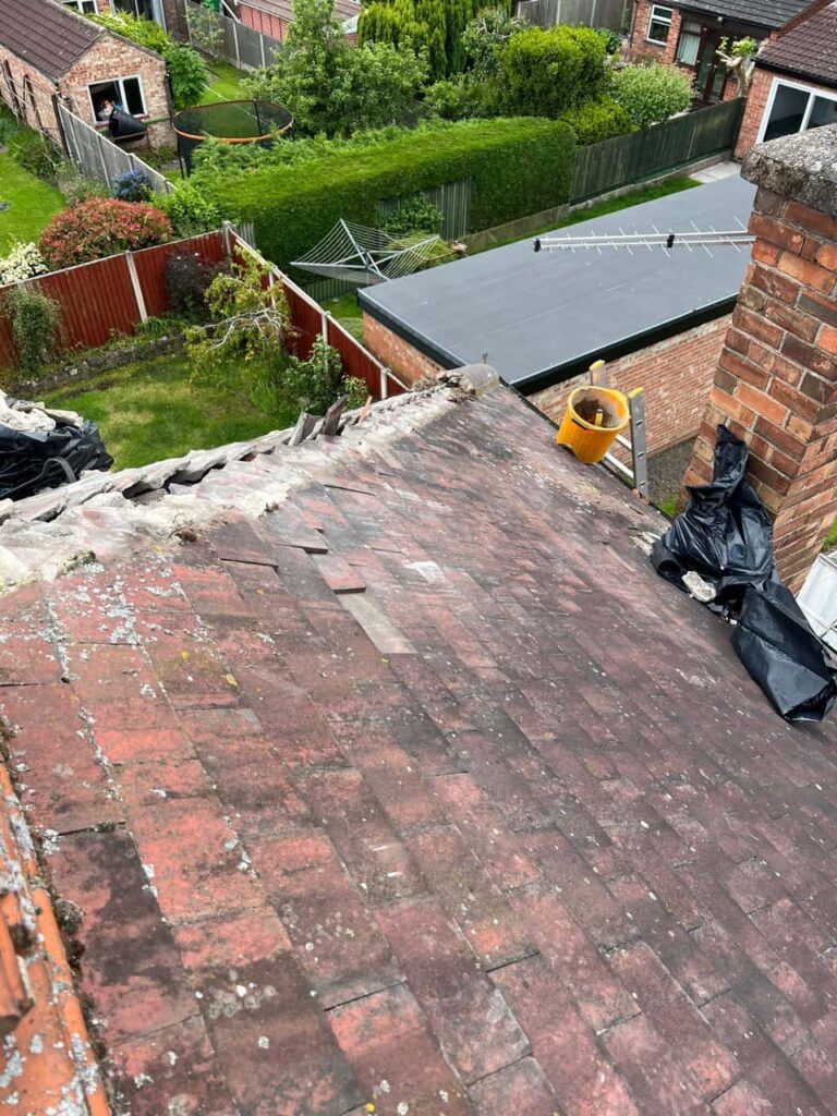 This is a photo of a roof where the hip tiles have been removed, and are just about to be replaced. Works carried out by Heanor Roofing Repairs