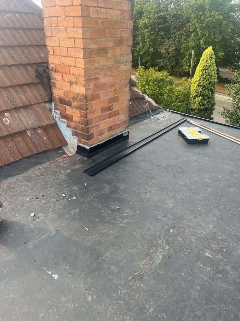 This is a photo of a flat roof which has just been repaired, there is also a chimney stack and some leadwork has also been dressed. Works carried out by Heanor Roofing Repairs